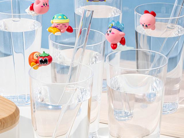 Small figures hanging on the rims of drinking glasses