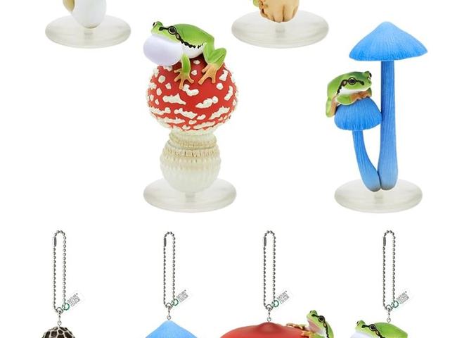 Frogs sitting under painted mushroom figures